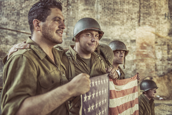 United States Army soldiers holding the American flag.