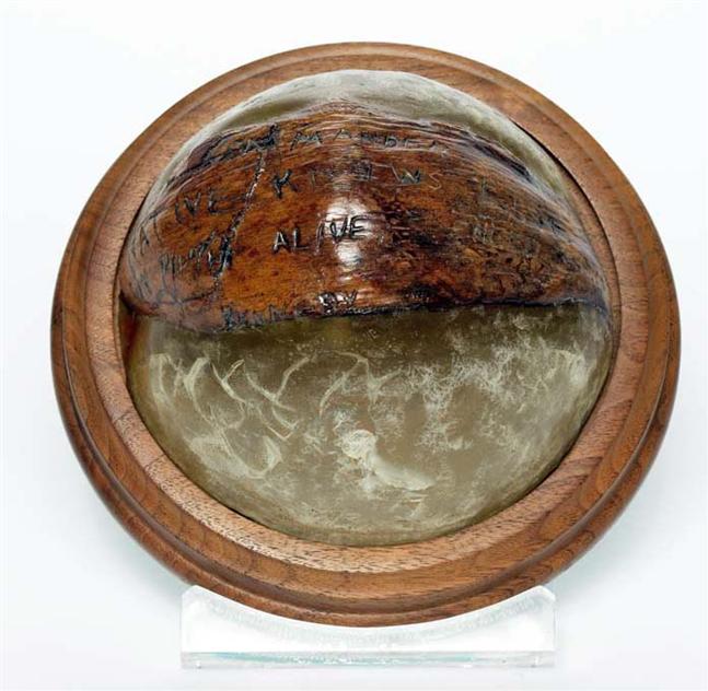 Coconut Shell Paperweight – Original coconut on which the rescue message was inscribed by Kennedy to rescue the crew of the PT-109 and delivered by natives, Biuku Gasa and Eroni Kumana, of the Solomon Islands.