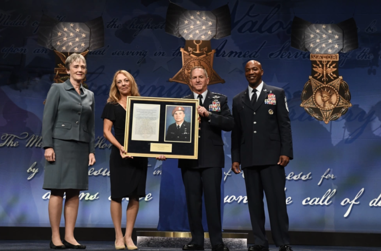 Secretary of the Air Force Heather Wilson, Valerie Nessel, Air Force Chief of Staff David L. Goldfein and Chief Master Sergeant of the Air Force Kaleth O. Wright standing on stage