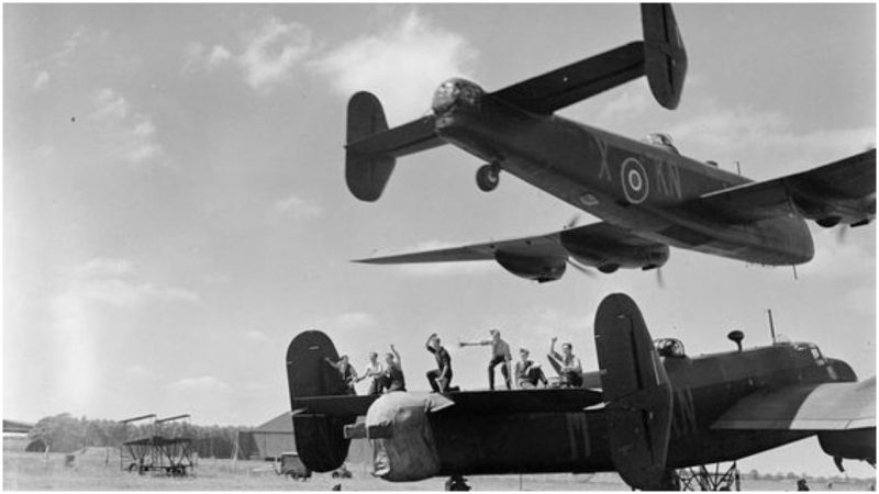 Low-level 'beat-up'. A Halifax II, JB911/KN-X of No 77 Squadron roars low over an audience of appreciative 'erks' during air tests at Elvington, Yorkshire, July 1943