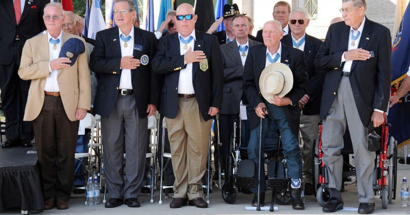 Medal of Honor recipients cover their hearts for a moment of silence during the opening ceremony of the Medal of Honor Convention at Soldier Field, Chicago, Sept 15, 2009.