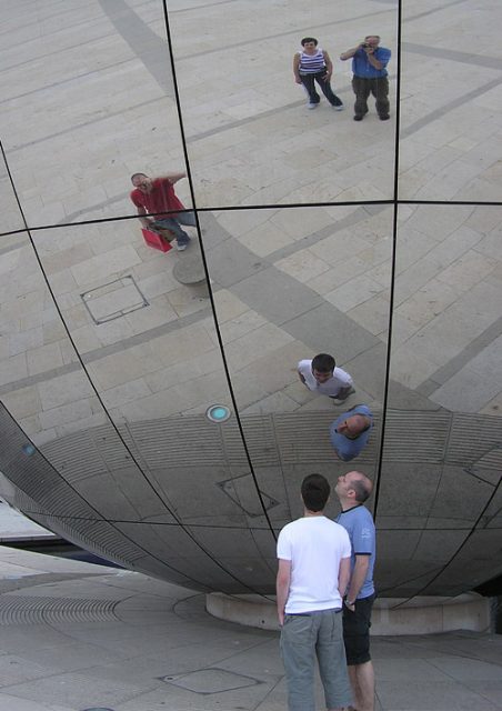 Reflections in a spherical convex mirror. The photographer is seen reflected at top right
