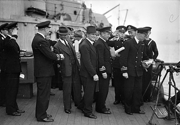 Rear-Admiral H M Burrough, CB, who commanded the close escort, shaking hands with Captain Dudley Mason of SS Ohio