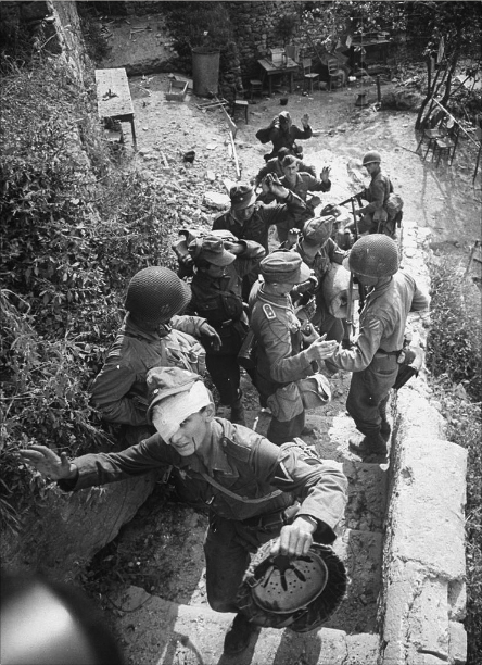 Cisterna, Italy 1944.German soldiers are captured during the battle for Cisterna, they’re being herded out of town by American GI’s of the 3rd Infantry to await transport to confinement areas.Photo: Dovima-2010 CC BY-NC 2.0