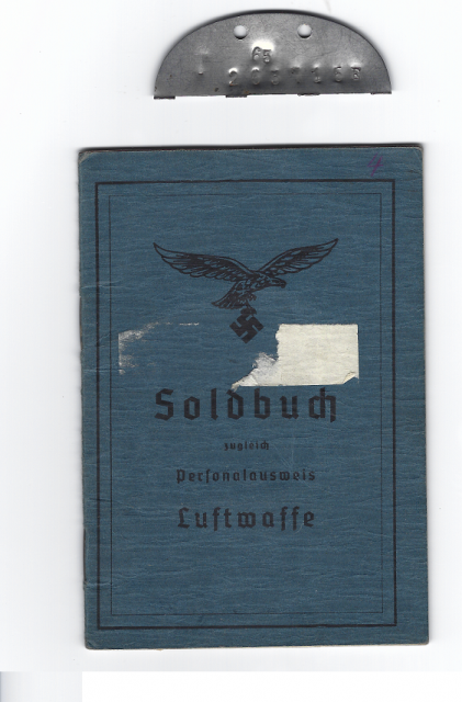 The Soldbuch and matching Erkennungsmarke (ID Tag) taken from the young German Paratrooper by those who buried him shortly after he was killed in a fierce firefight in the forest of Dreierwalde, Germany in April 1945. The ID tag was broken in half, with the other half staying with the body.