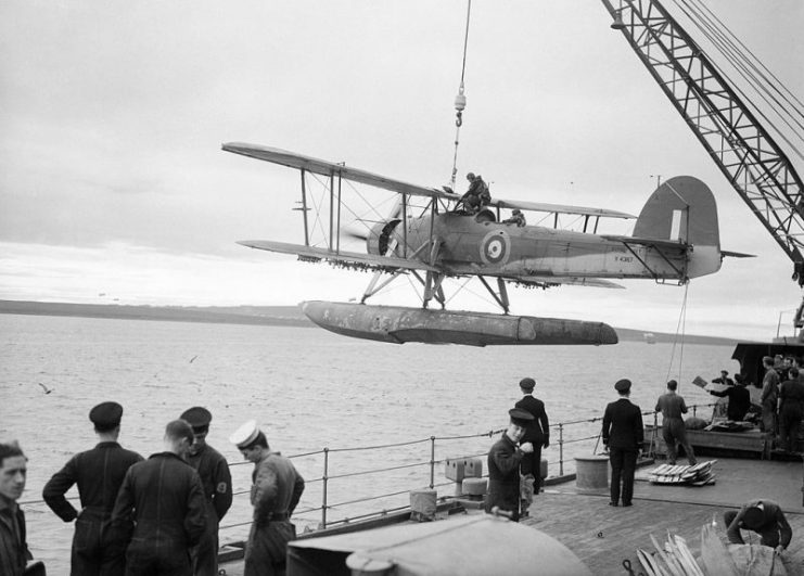 A Fairey Swordfish floatplane being hoisted aboard the battleship HMS Malaya in October 1941