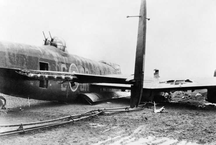 Damaged Avro Lancaster of No. 101 Squadron RAF (identified by squadron code SR on fuselage) at Ludford Magna, Lincolnshire, after a successful crash-landing on returning from a raid to Augsburg on the night of 25/26 February 1944.