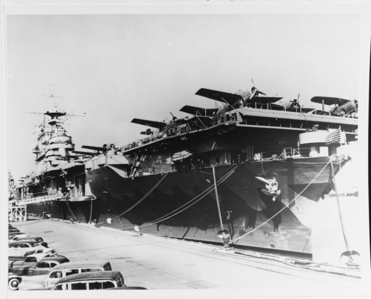 Hornet moors alongside Pier 7, NOB Norfolk, February 1942. The planes parked on the forward end of her flight deck (visible in the foreground) are Grumman F4F-4 Wildcats of VF-8 and Curtiss SBC-4s from either VB-8 or VS-8. (U.S. Navy Photograph 19-N-28429, National Archives and Records Administration, Still Pictures Division, College Park, Md.)