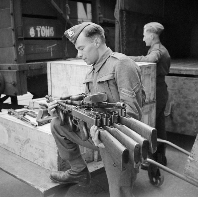 Thompson submachine guns, or “Tommy guns,” being un-crated at an ordnance depot in the UK after their arrival from the US through the Lend-Lease scheme, 23 March 1942