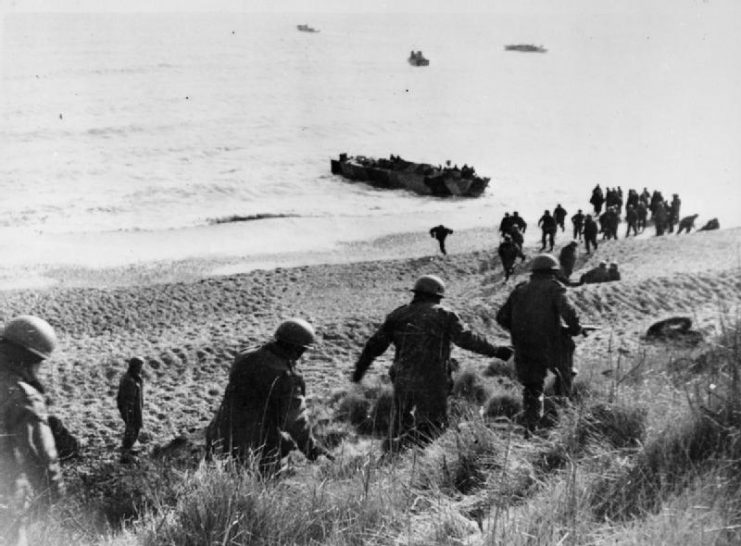 Troops of the covering force and paratroopers practice their withdrawal to the landing craft during training in Britain