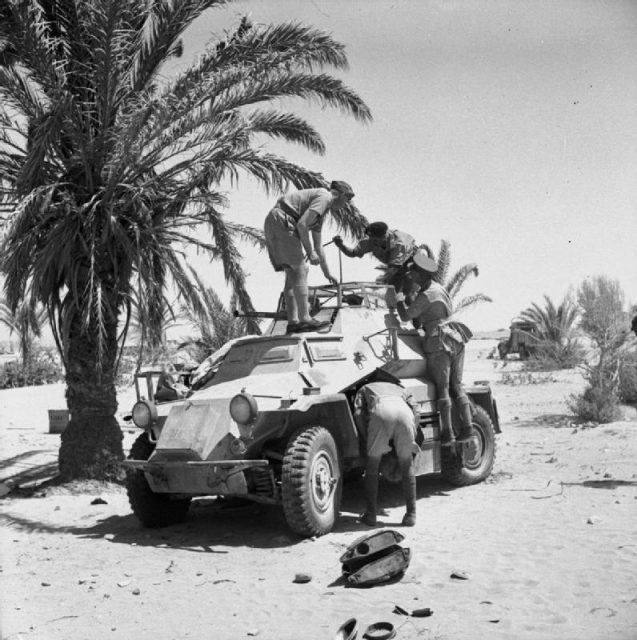 British soldiers inspecting a captured German SdKfz 222 armoured car, 24 June 1941.