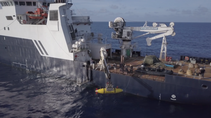 The AUV Hydroid Remus 6000 is deployed from the R/V Petrel. The autonomous underwater vehicle is capable of operations in up to 6,000 meters of water. Photo courtesy of Paul G. Allen’s Vulcan Inc.