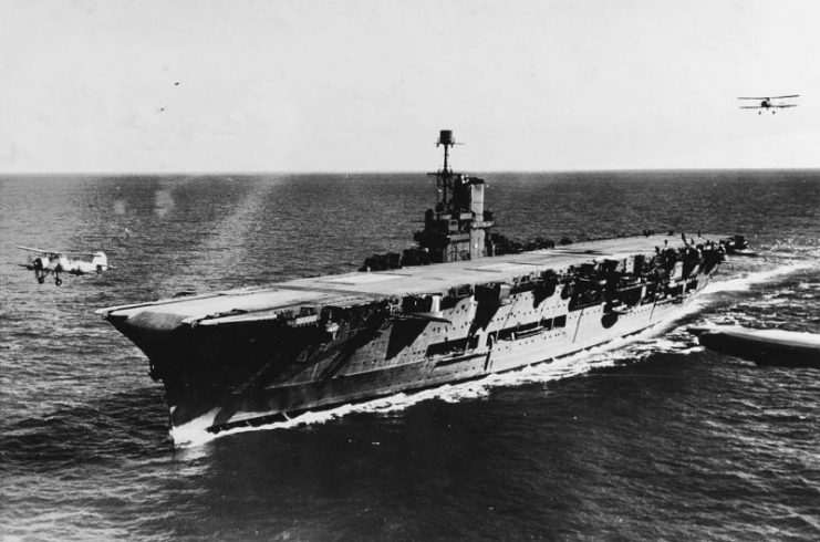 A Swordfish taking off from the aircraft carrier HMS Ark Royal, with another passing by astern, circa 1939