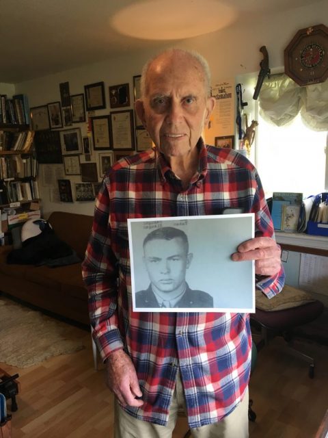 Dean Ladd holding a picture of Sgt. Maples, the man who saves his life.