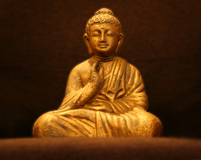 A golden buddha statue sits in peaceful meditation.