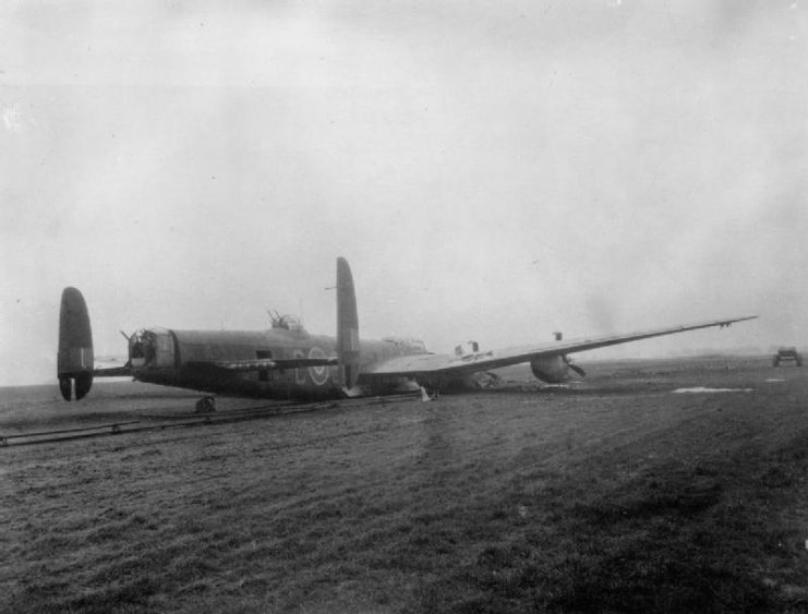 Avro Lancaster B Mark I, ME590 ‘SR-C’, of No. 101 Squadron RAF, lies on the FIDO pipework at Ludford Magna, Lincolnshire, after a successful crash-landing on returning from a raid to Augsburg, February 1944.