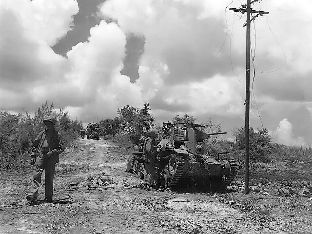 Marines check out a Japanese tank knocked out of action.