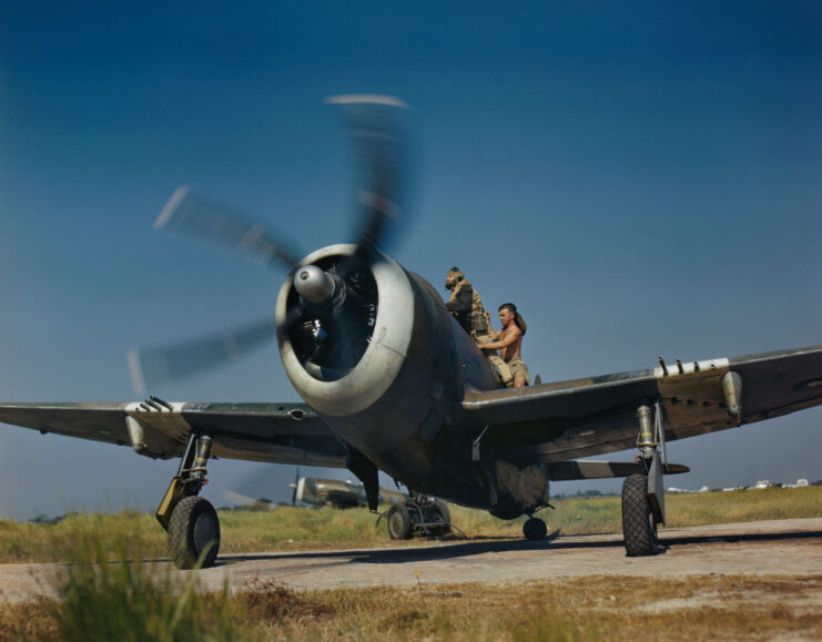 Royal Air Force (RAF) airmen standing around the cockpit of a Republic P-47D-25 "Thunderbolt Mark II"