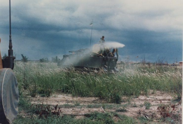 U.S. Army armored personnel carrier (APC) spraying Agent Orange over Vietnamese rice fields during the Vietnam War.