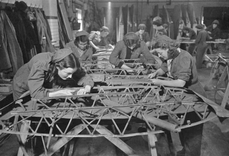 Workers carrying out salvage and repair work on a wing of a Swordfish