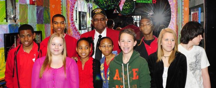 Tuskegee Airman Dr. Robert T. McDaniel, 88, poses with a group of local youths during a celebration of the opening of “Red Tails.” The movie is based on the first all-black squadron of bombers, pilots and maintainers in the Armed Forces during World War II. (U.S. Air Force photo/Senior Airman Martha Whipple)