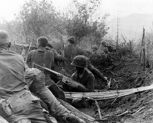 Men of the 1st Brigade, 101st Airborne Division, fire from old Viet Cong trenches
