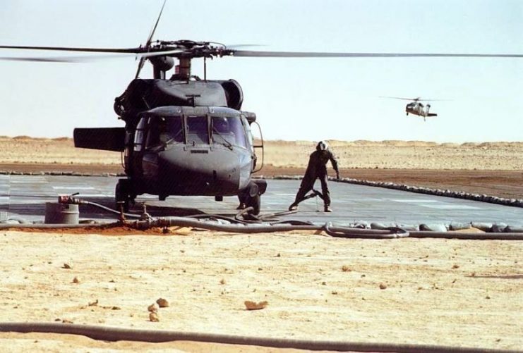 UH-60A Blackhawk being refueled, 101st Airborne Division Rapid Refuel Point (RRP) capable of servicing twenty helicopters simultaneously; fuel handling personnel from 102d Quartermaster Detachment, Logistical Base CHARLIE, Northern Province, Saudi Arabia