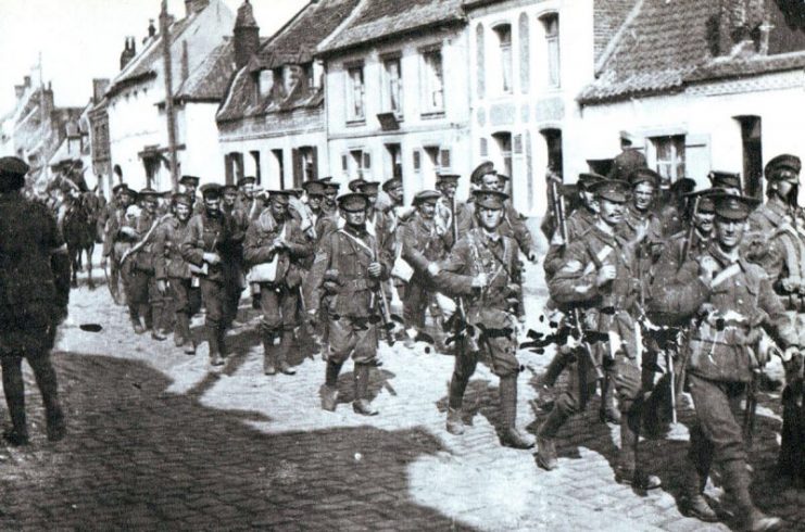 British infantry marching through a French village in August 1914