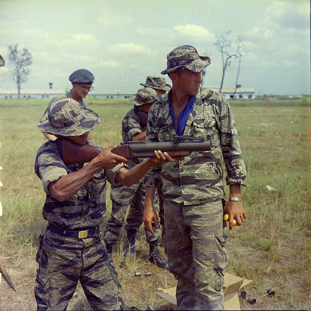 SSG Alvin J. Rouly taught a Vietnamese Civilian Irregular Defense Group (CIDG) trainee how to use a M79 grenade launcher. Camp Trai Trung Sup, Republic of Vietnam, was the 3rd Corps’ Basic Training Center for CIDGs . The camp was commanded by the Vietnamese Special Forces (LLDB) and advised by Detachment A, 5th US Special Forces Group.