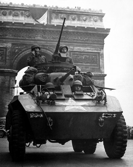 American troops in an M8 passing the Arc de Triomphe after the liberation of Paris
