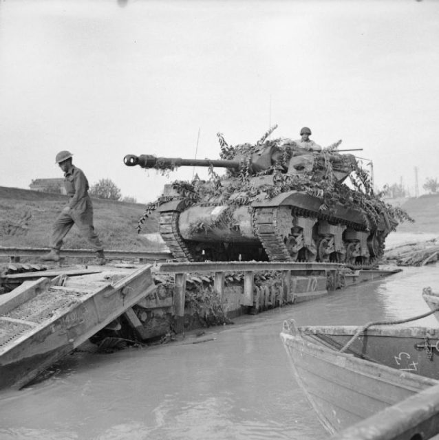 An Achilles 17pdr Self-propelled anti-tank gun crossing the River Savio on a Churchill ARK which was driven into the river, October 24, 1944.