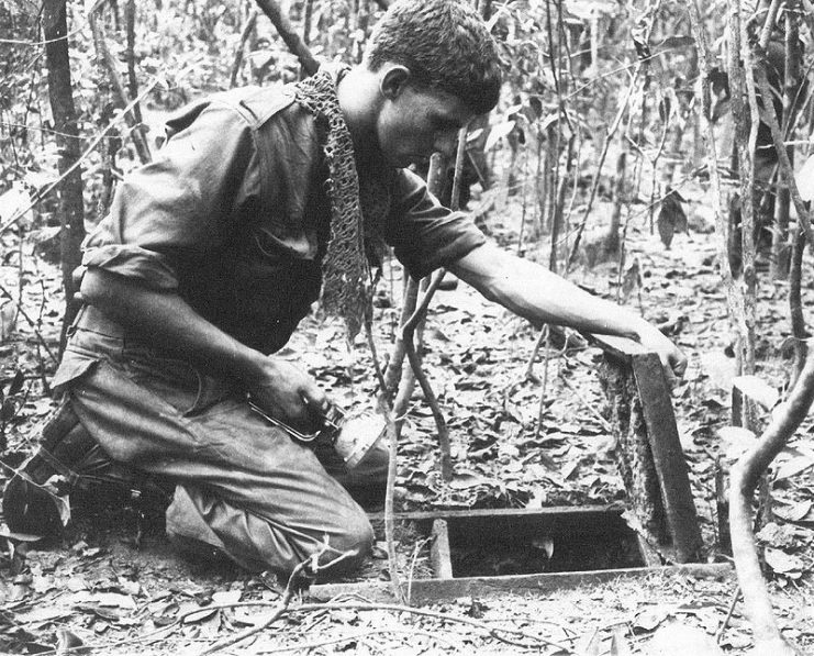 Australian soldier looking into a Viet Cong tunnel discovered during Operation Crimp, Vietnam.