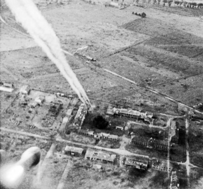 Rockets fired from a Hawker Typhoon of No 181 Squadron, RAF, at buildings on Carpiquet airfield. The 3rd Canadian Division took Carpiquet on 4 July.Operation Windsor, Part of Battle for Caen