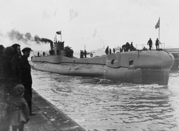 British T class submarine HMSM TRIDENT underway entering dock.