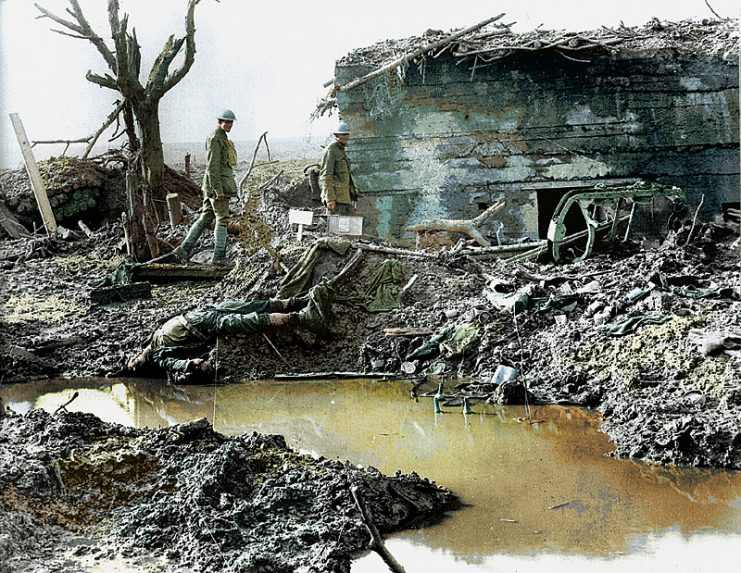 Canadian soldiers survey a destroyed German bunker during the battle