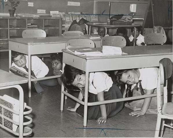 Carroll & Smith Sts. Bklyn. hold a “take cover” drill practice Here youngsters crawl under their desks