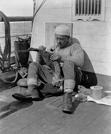 George Murray Levick (1877–1956), British Antarctic explorer, member of Robert Falcon Scott’s antarctic expedition of 1910-1913, the Terra Nova Expedition, skinning a penguin in the “Terra Nova”