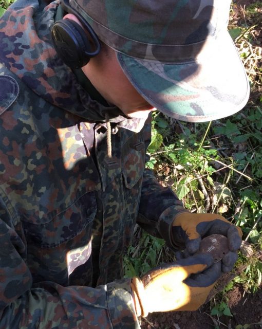 The ID-Tag was found by Legenda member Gytis Jasenauskas. Seen here moments after he found it, he is carefully checking it for the markings which happened to be perfectly preserved.