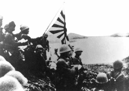 Japanese troops raise the Imperial battle flag on Kiska Island in the Aleutians on June 6, 1942.