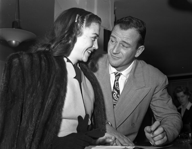 Esperanza Baur and John Wayne staring at each other