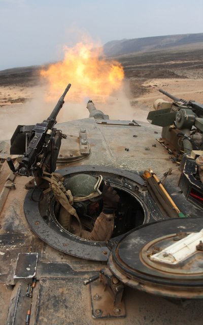 M1A1 firing its main gun as seen from the loader’s hatch. The M240 is visible left while the M2HB is visible right.