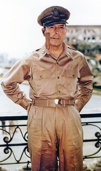 MacArthur with five-star-rank badges on the collar. He is wearing his field marshal’s cap and smoking a corncob pipe.