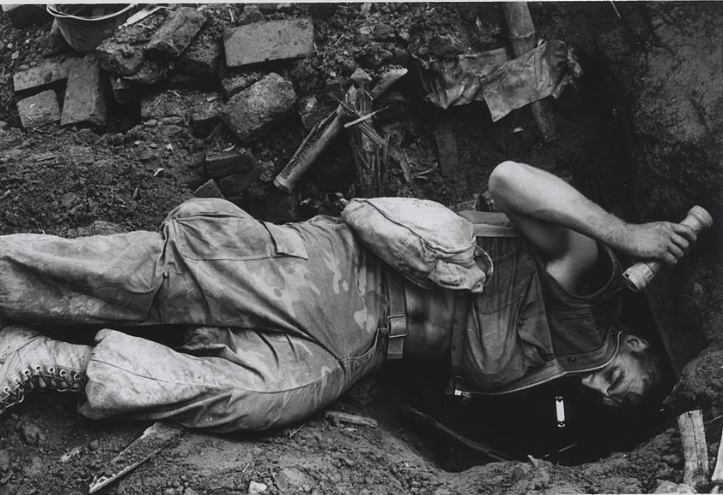 Marine Lance Corporal John R. Gartrell (Fort Smith, Arkansas) crawls into a captured North Vietnamese bunker during Operation Meade River, southwest of Da Nang.