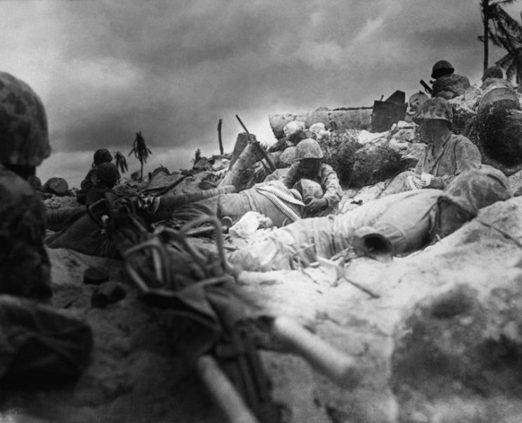 Marines seek cover behind the sea wall on Red Beach 3, Tarawa.