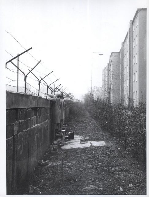 Nov. 30, 1961. As the holiday season approaches, West Berliners try to stay in contact with friends in East Berlin by waving to them across the border.