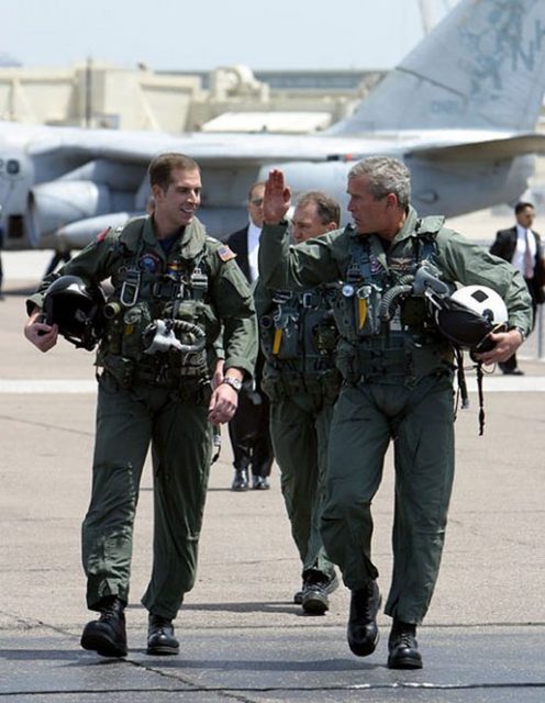 President Bush, with Naval Flight Officer Lieutenant Ryan Philips, after landing on USS Abraham Lincoln prior to his “Mission Accomplished” speech, May 1, 2003
