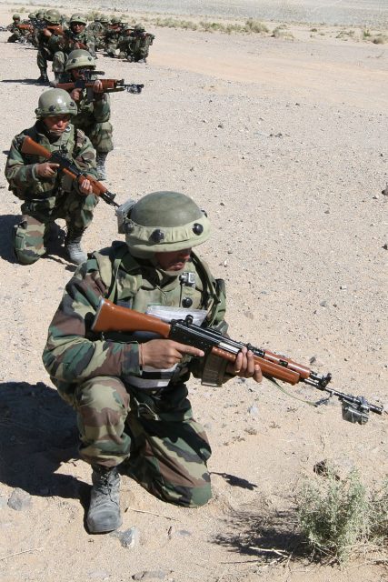 The 1st Battalion of 1 Gurkha Rifles of the Indian Army takes position outside a simulated combat town during a training exercise.