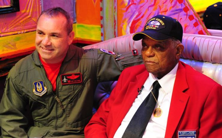 Tuskegee Airman Dr. Robert T. McDaniel, 88, poses with Col. Kurt Gallegos, 301st Operations Group commander, during a celebration of the opening of “Red Tails.”(U.S. Air Force photo/Senior Airman Martha Whipple)