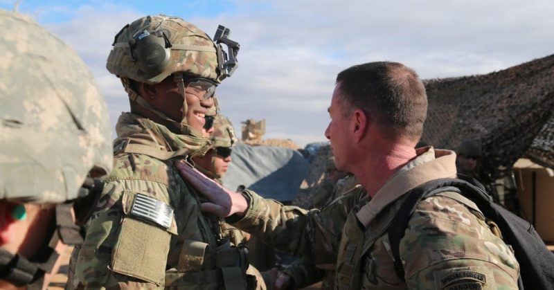 U.S. Army Command Sgt. Maj. William F. Thetford, U.S. Central Command senior enlisted leader, presents coins to U.S. Army Soldiers during a training exercise in Iraq, Jan. 18, 2019. ( U.S. Army photo by Sgt. Franklin Moore)