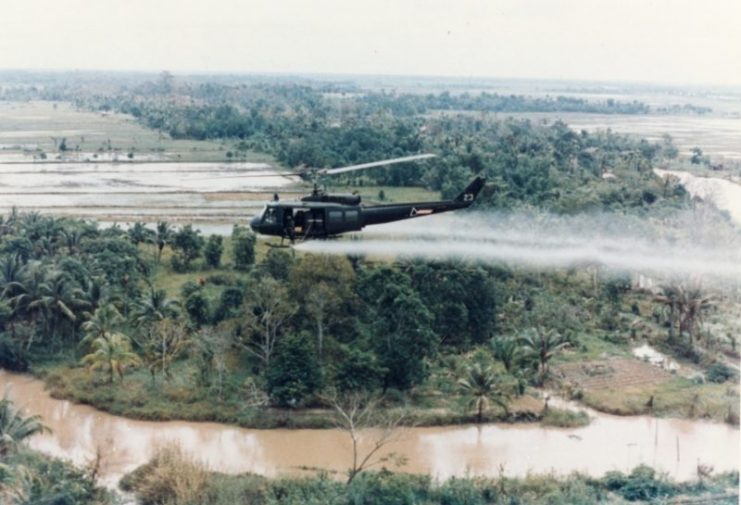 U.S. Huey helicopter spraying Agent Orange over Vietnam.